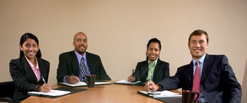 A diverse group of businesspeople seated around a conference table.