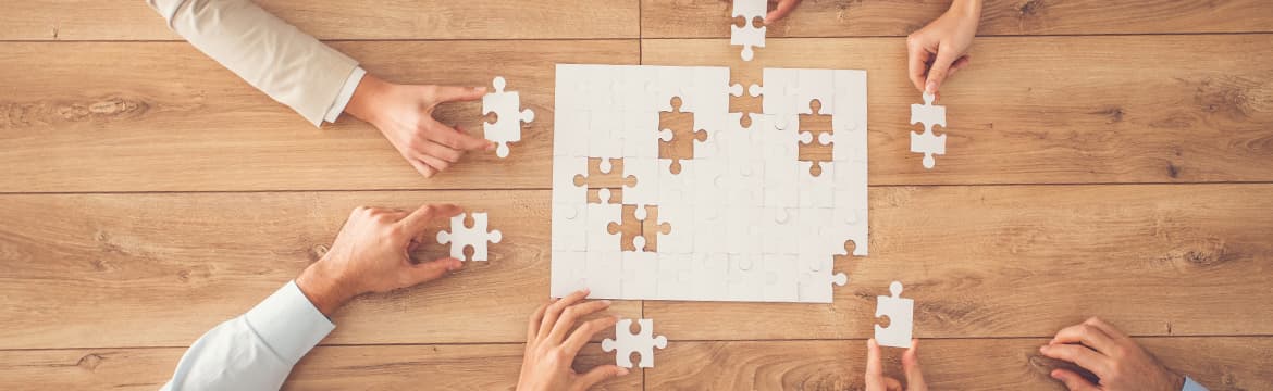 Photo of people putting together a blank puzzle