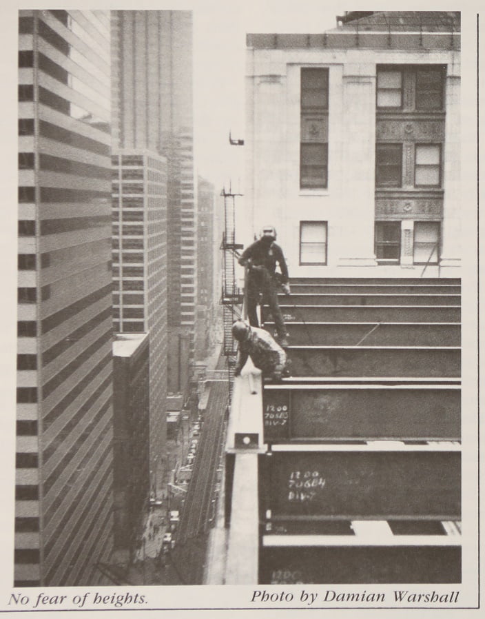 Construction workers high above the city
