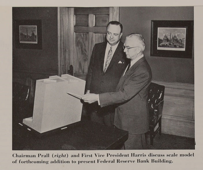 Executives reviewing a scale model of the expansion