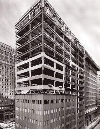 Cement and steel framework are visible during construction of an addition to the Chicago Fed building.