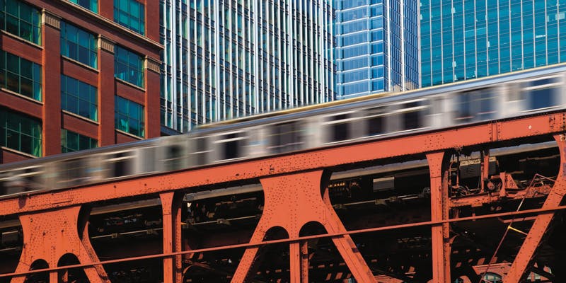 An elevated train in Chicago in motion on its track. 